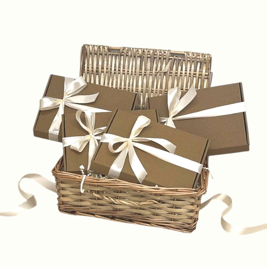 Self-care gift hamper with 4 mini boxes of skincare and indulgent treats