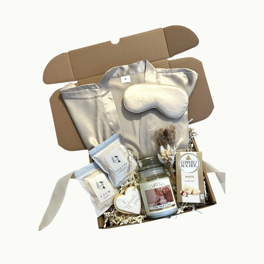 Cosy self care hamper with satin robe, candle, bath salts and chocolate for a relaxing night in