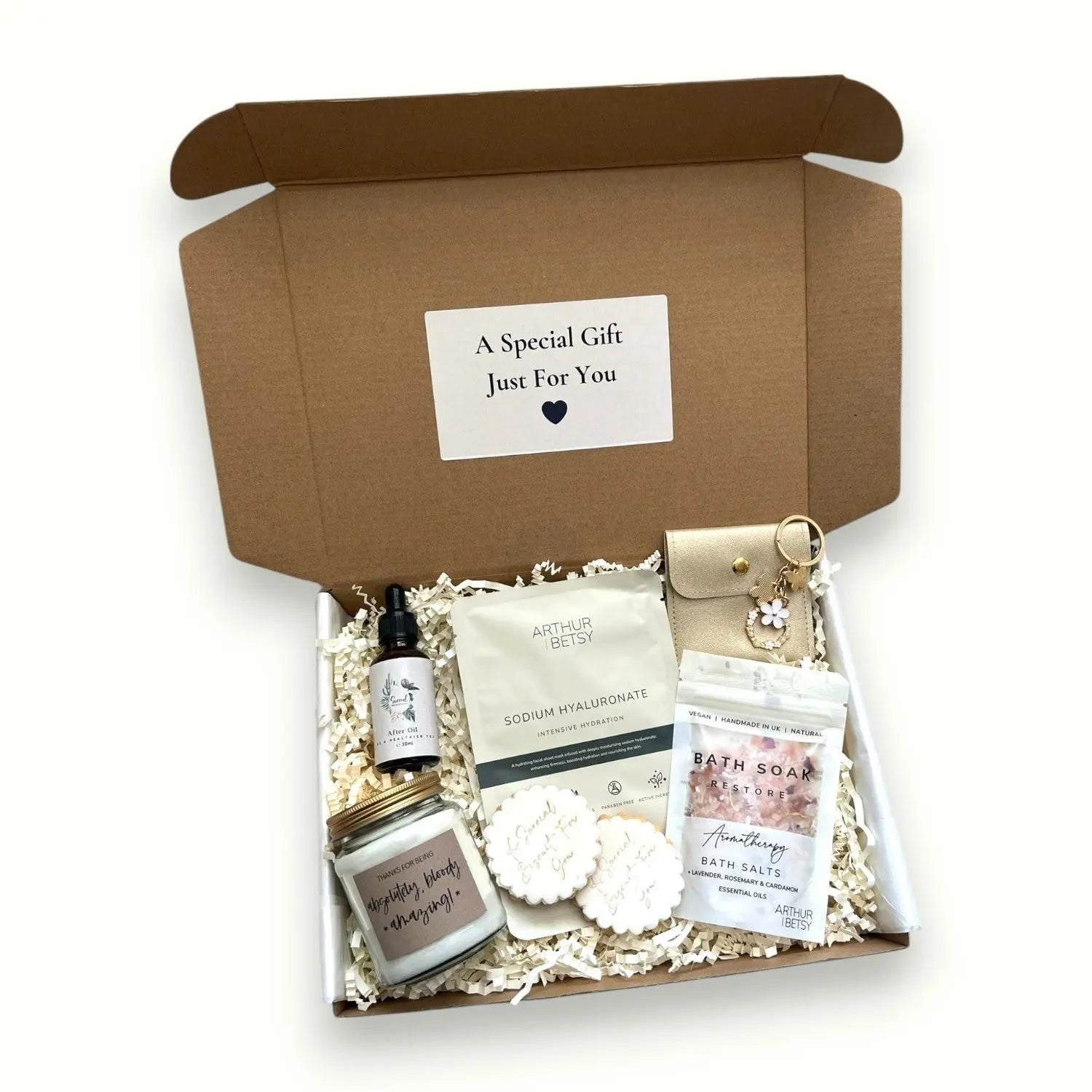 Cosy pamper hamper with soothing candle, oil, face mask, and sweet cookies