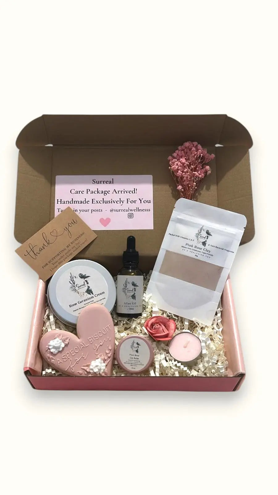 Personalised Gift set with various items including a tealight candle, rose clay mask, rose geranium biscuit and lip balm Surreal Hampers UK