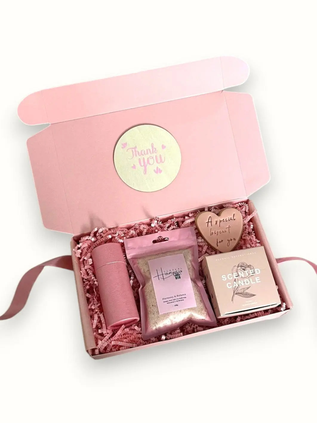 Pink gift box with skincare products and a 'thank you' card 