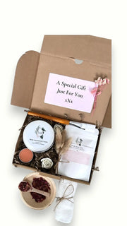 Self-care gift box featuring natural skincare items, rose geranium cream
