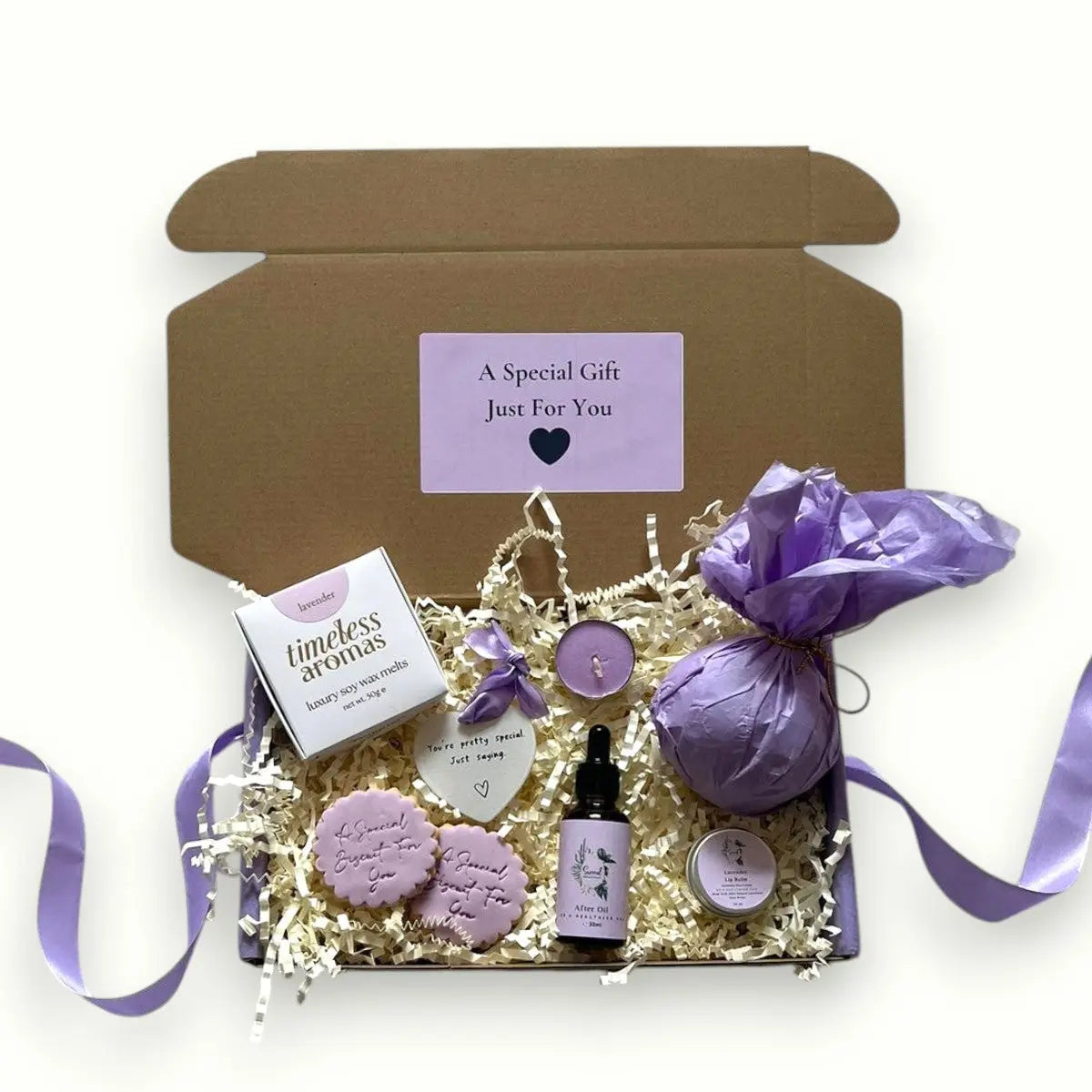 Self-care gift set including bath bomb, tealight candle, cookies, wax melt, and oil, Pamper Skincare Hampers | Luxury Gifts for Her UK