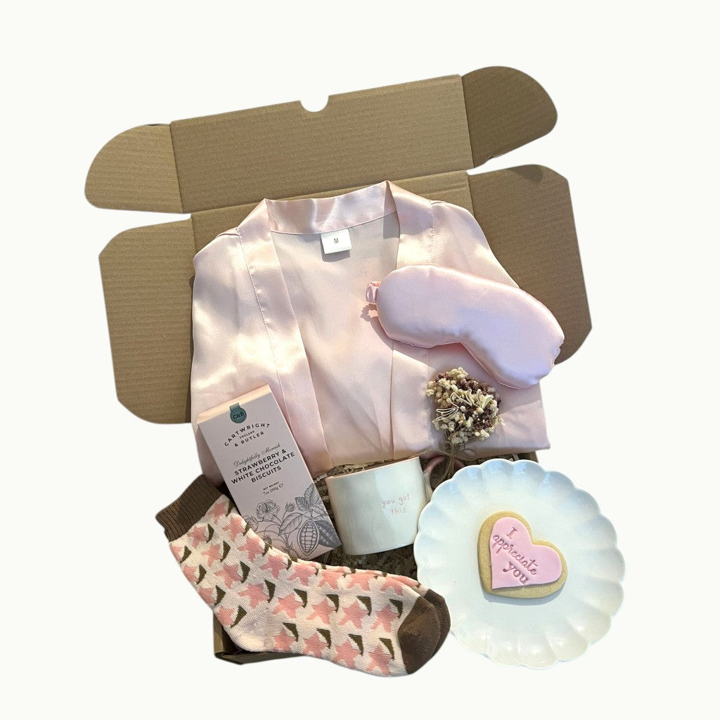 Cosy feel good gift box with robe, socks, sweet treats and mug for relaxing and uplifting moments at home