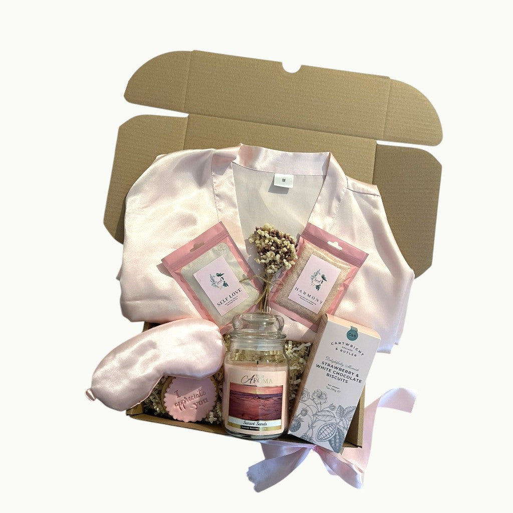 A thoughtful gift box for her filled with soothing self care items and sweet treats for a moment of calm