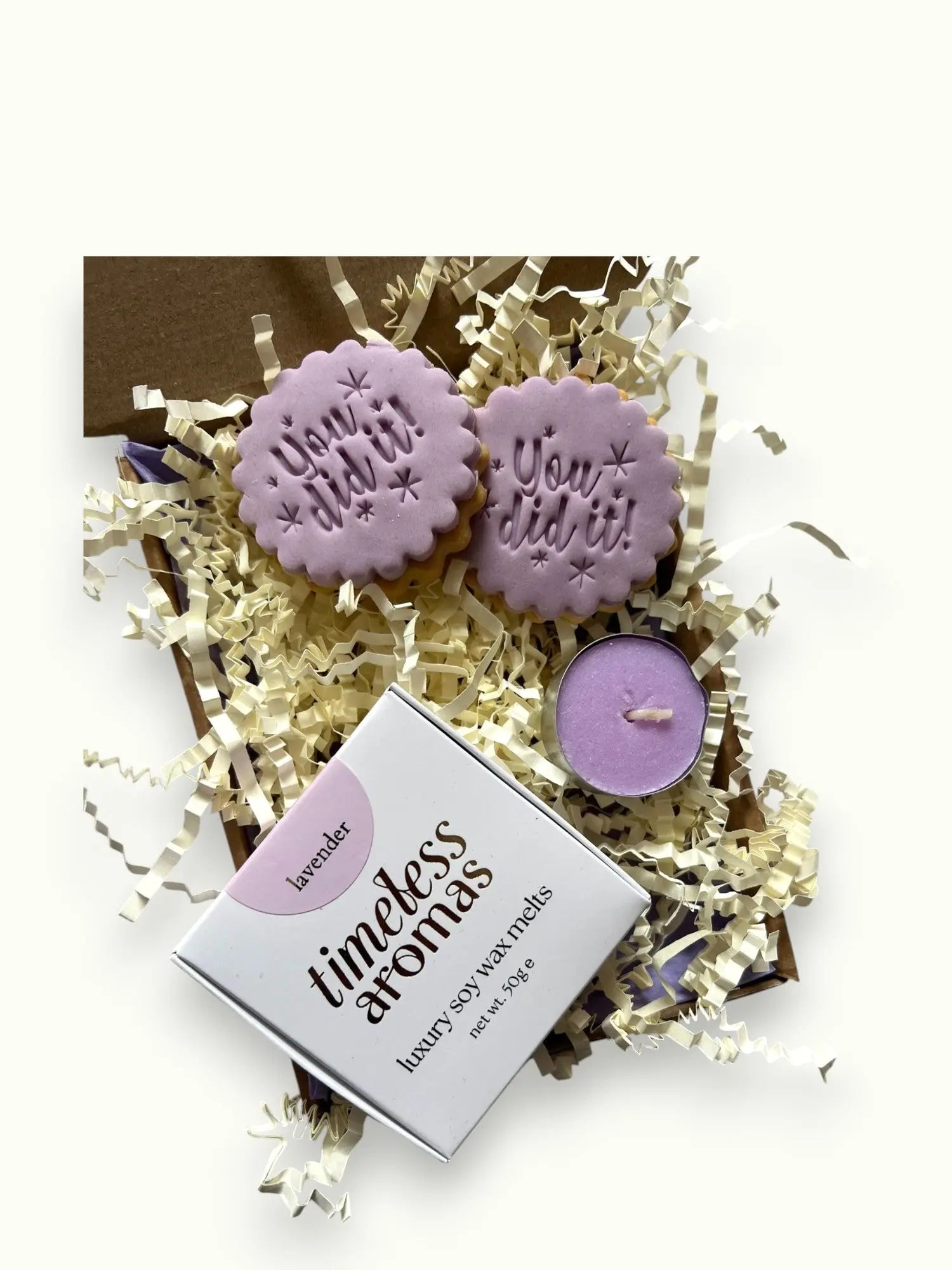 Set of lavender wax melts and candles with a 'timeless aromas' box on a white background