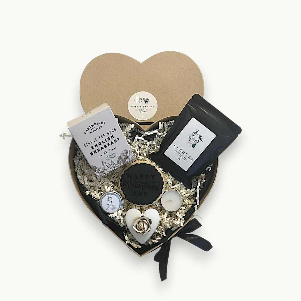 Black heart-shaped self care gift box for women with spa-style pamper items and candle birthday and valentines